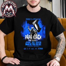 A man sitting on a couch wearing the black Dresden Germany Papa Roach Poster For Messe On June 23 Rise of The Roach Tour 2026 Vintage T-Shirt with a blue rock concert print.