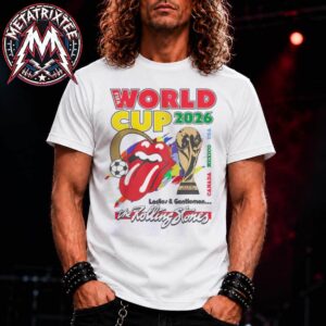 A man wearing the white FIFA World Cup Rolling Stones T-Shirt featuring the iconic red tongue logo next to the official World Cup trophy graphic.